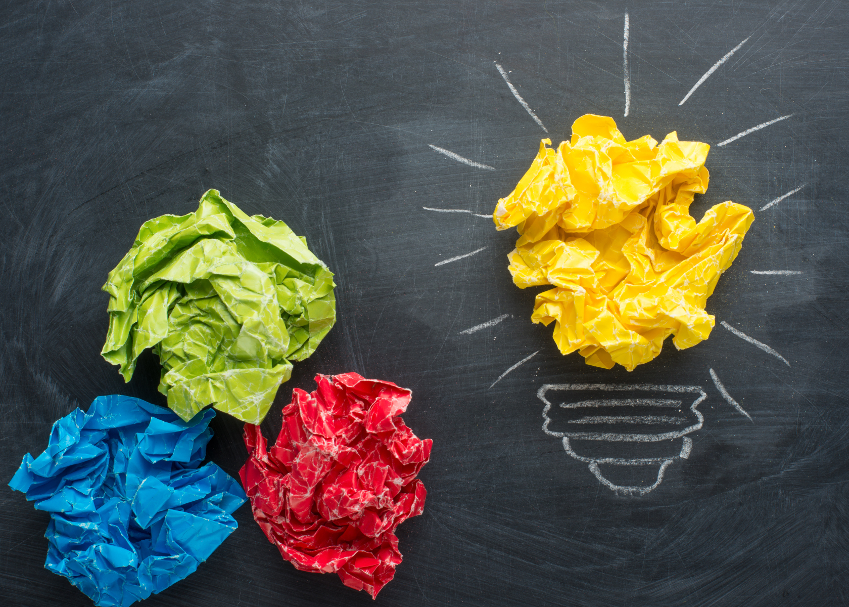 Good idea concept crumpled paper ball lightbulb on blackboard