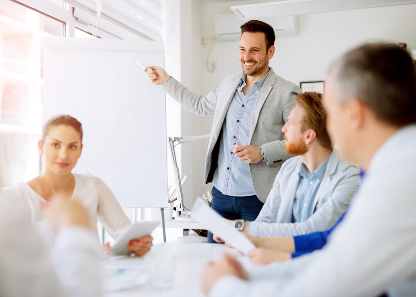 Business plan explained on flipchart by CEO to employees