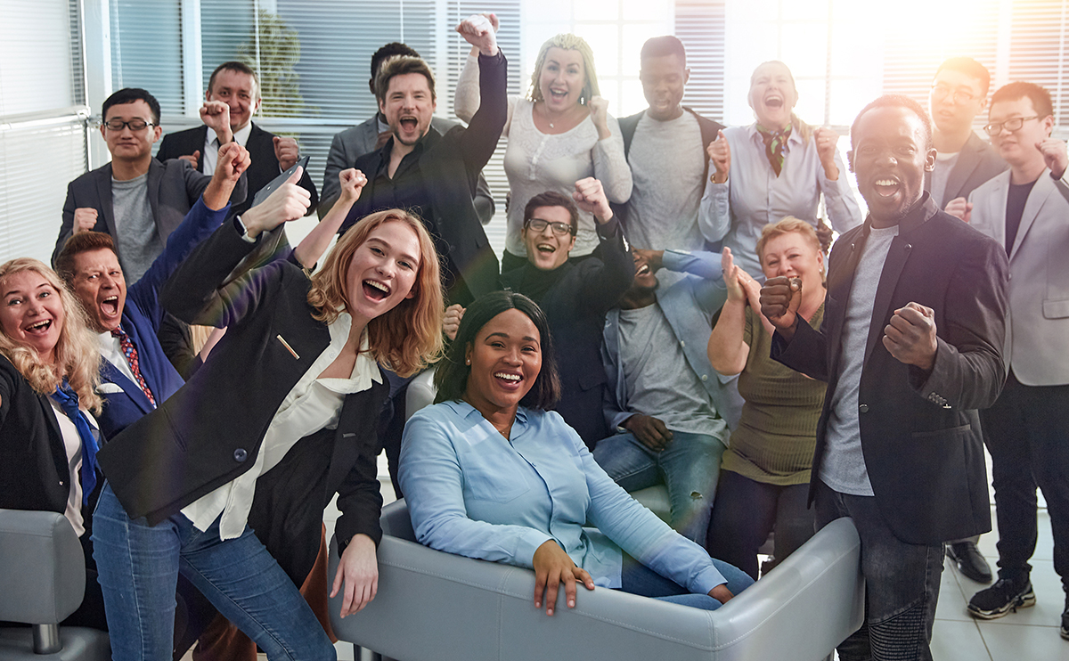 happy team of diverse corporate employees in the office lobby.