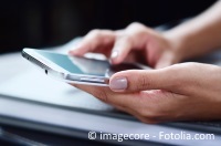 Hands of a businesswoman using a smartphone