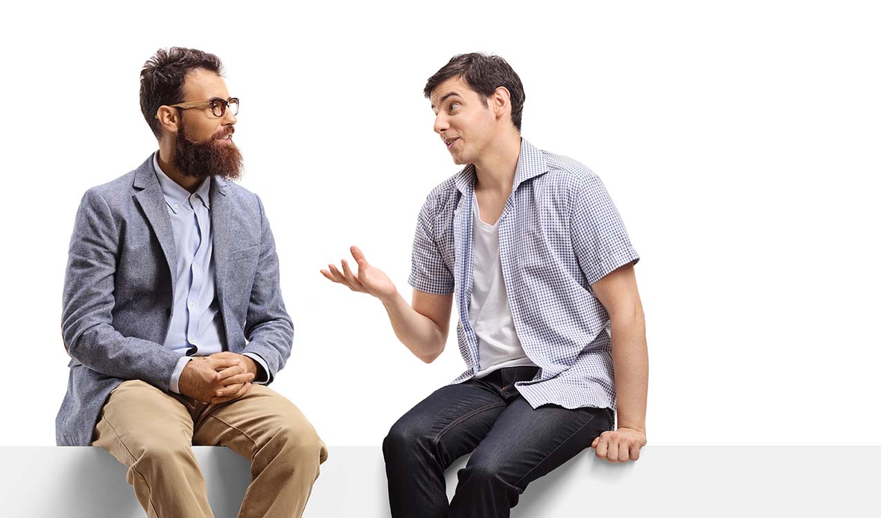 Men sitting on a banner and talking