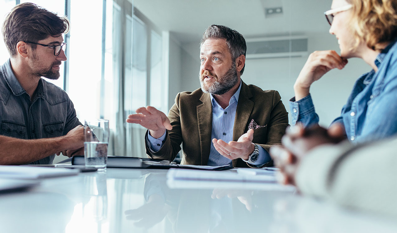 Businessman explaining new business ideas to colleagues